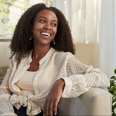 Woman sitting on the couch smiling